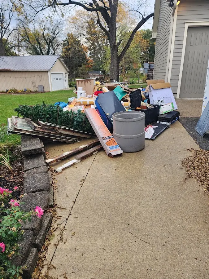 Dumpster being loaded with debris for Commercial Dumpster Rental in Floyds Knobs